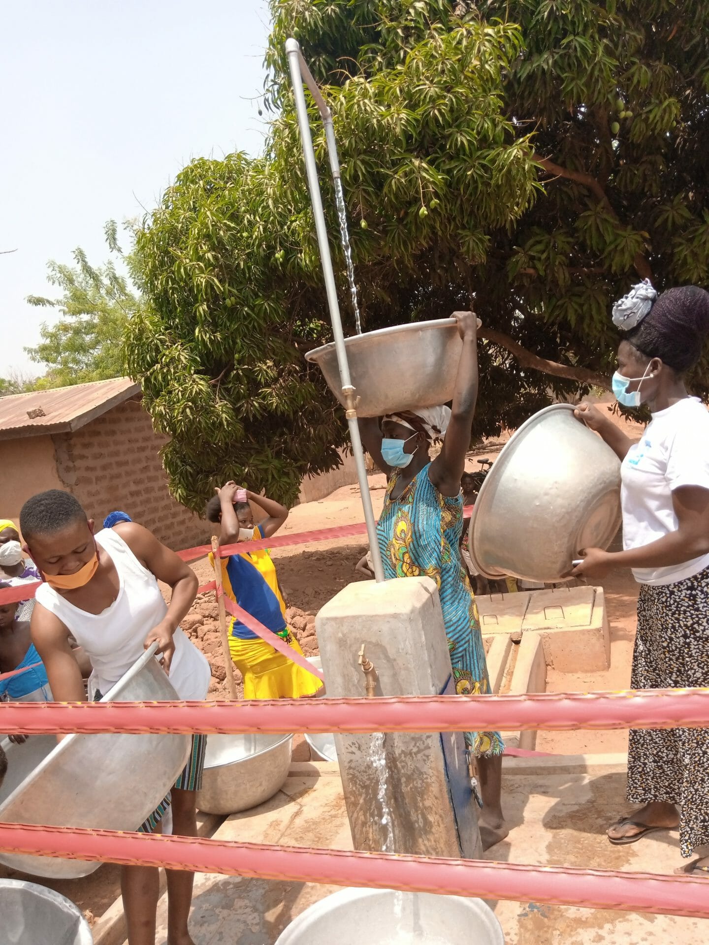 Residents of Tinjase fetching water immediately after commissioning