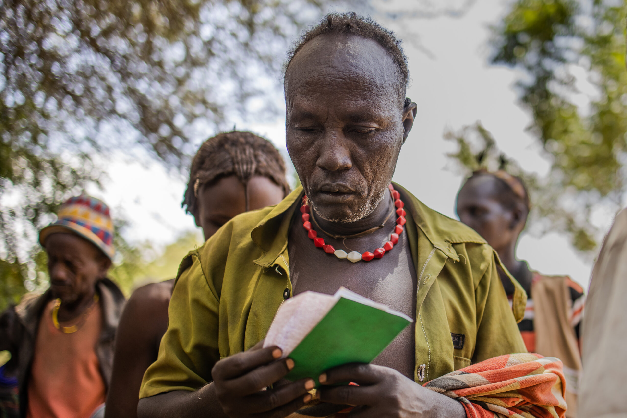 Loborose Borokou,    cash beneficary waits at a bank to withdraw money in Dassanch Woreda, South Omo, SNNPR, Ethiopia.