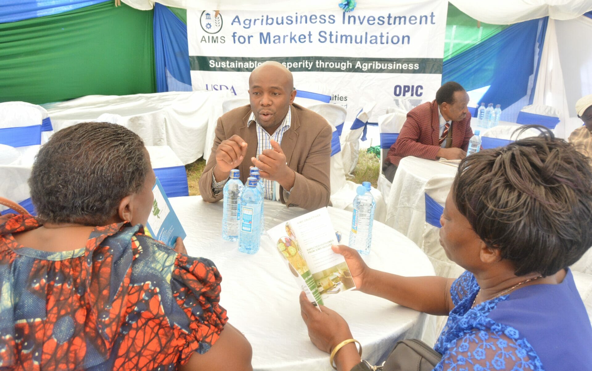 AIMS Credit Specialist,Benard Muhande responding to a question from a group of SMEs engaing in horticulure during an AIMS-supported B2B session held during the Machakos ASK even,June 2016
