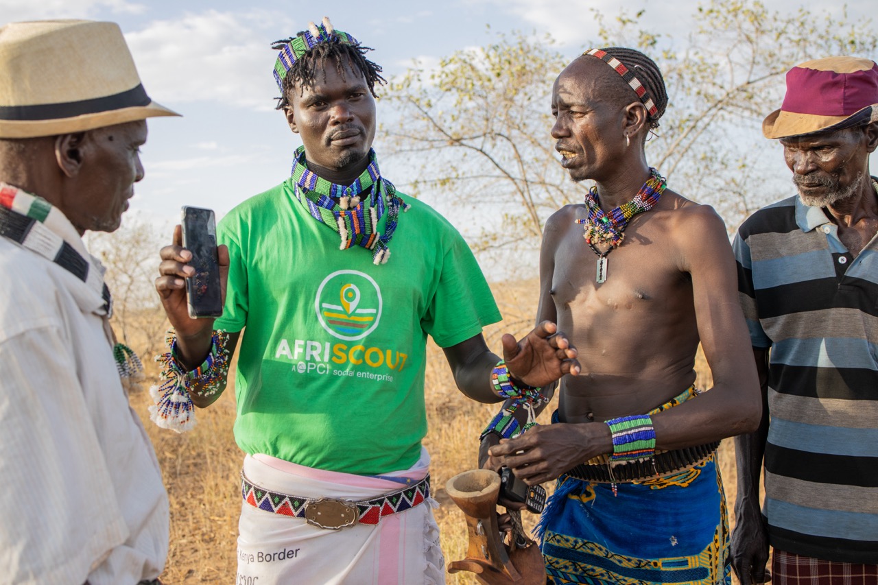 Kitabo Wele, 25, Afriscout promoter, explains the use of Afriscout app with a pastorialist Andulsha Kefa, 45, Muda Gela,66 (on right) and Kole Kilkila, 53, inHamer Woreda, South Omo zone, SNNPR, Ethiopia.