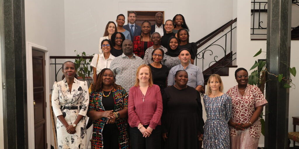 Group shot positioned up a set of stairs of attendees at the Familia Imara launch event.